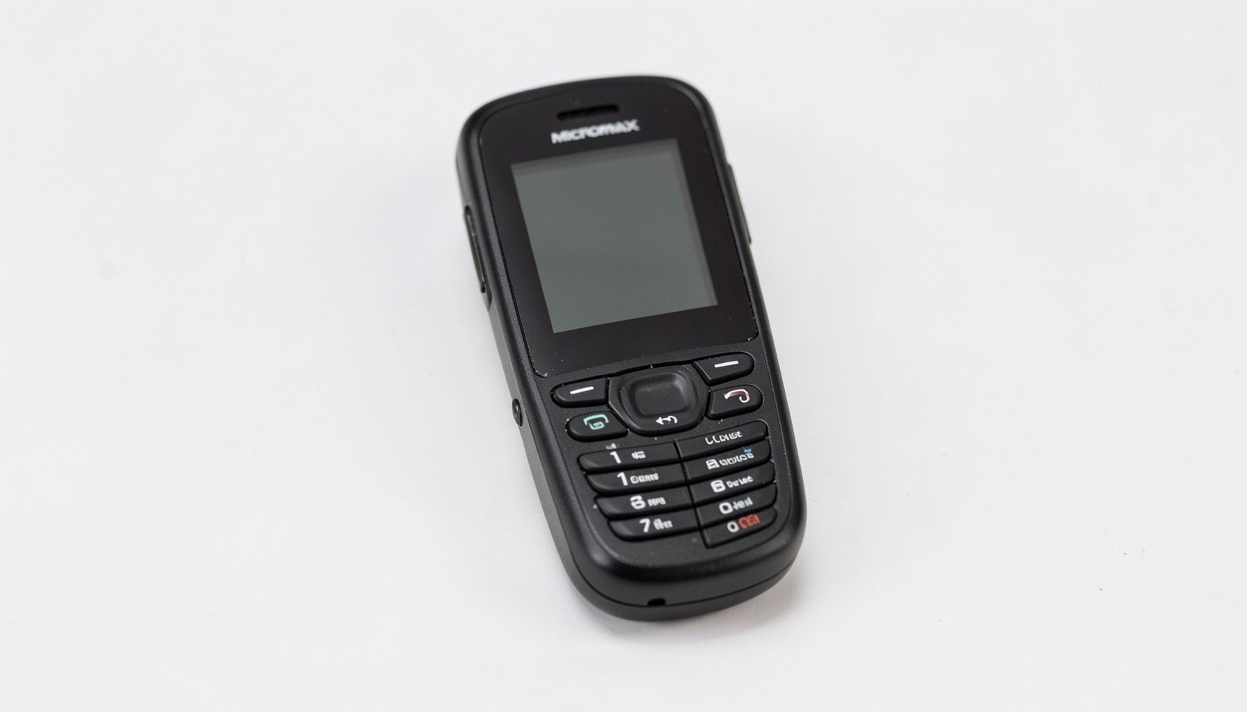 A compact black Micromax phone with a small screen and prominent keypad, photographed on a clean light background.