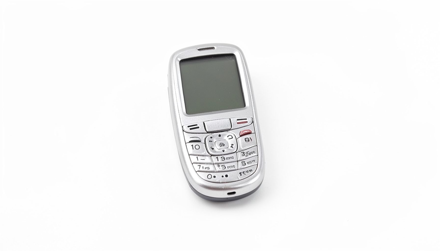 A compact silver flip-style feature phone with a small screen and numeric keypad, photographed on a clean white background.